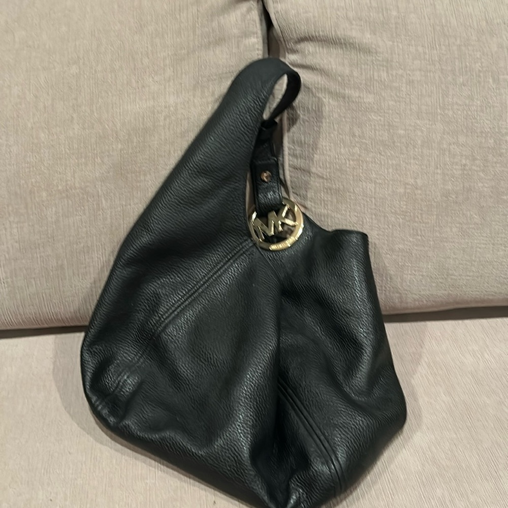 MK medium hobo bag with gold hardware on strap.